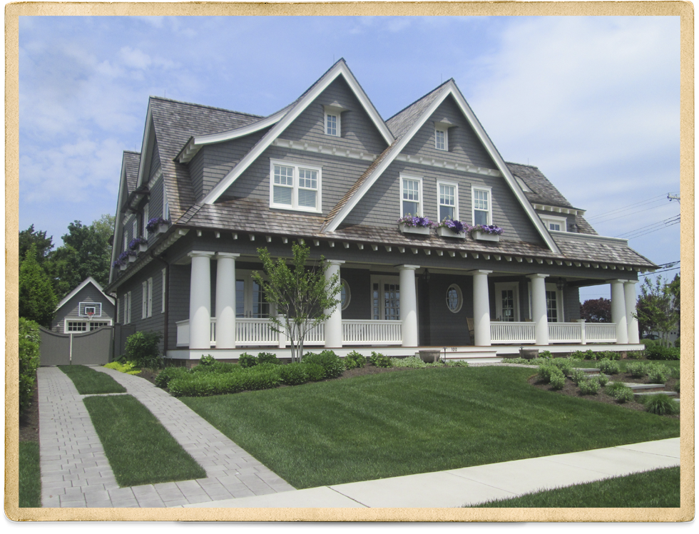 Gray Cedar Shake Two Story With White Trim And Columns On Front Porch