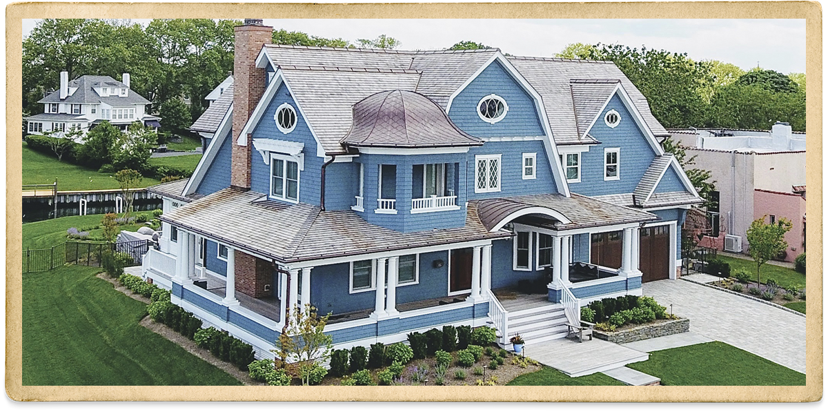 Two story blue cedar shake with white trim