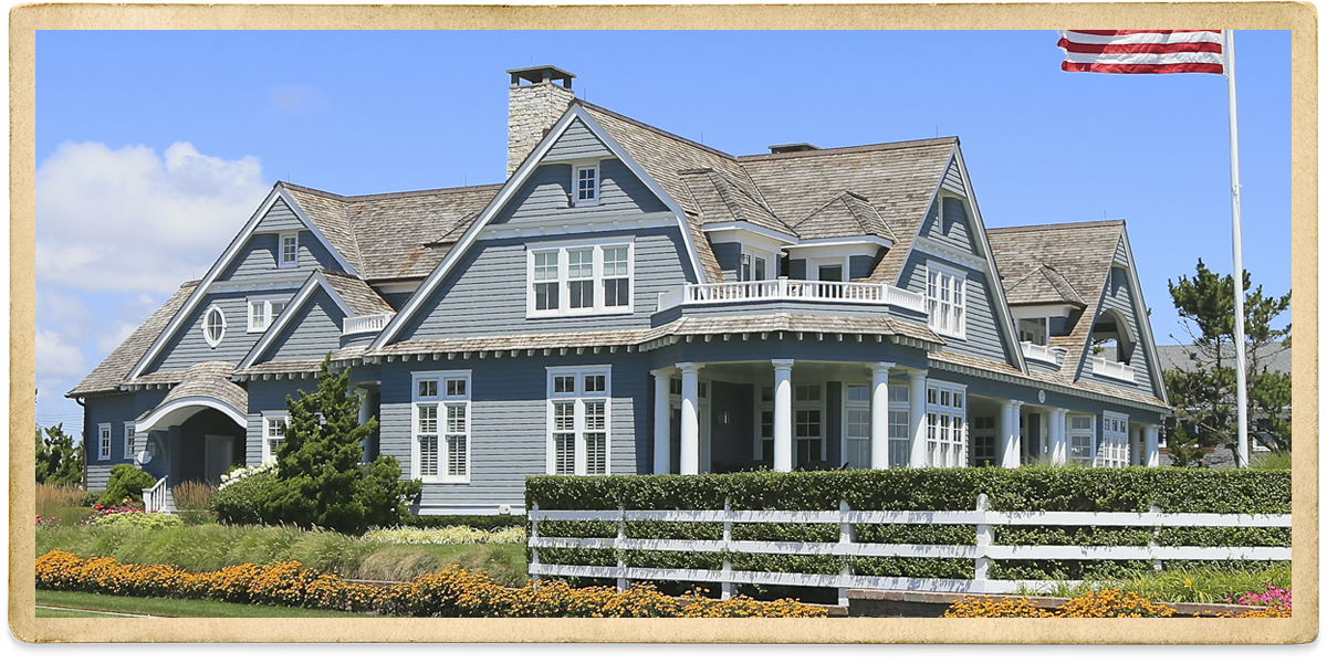 Blue-gray two story with white trim and fence