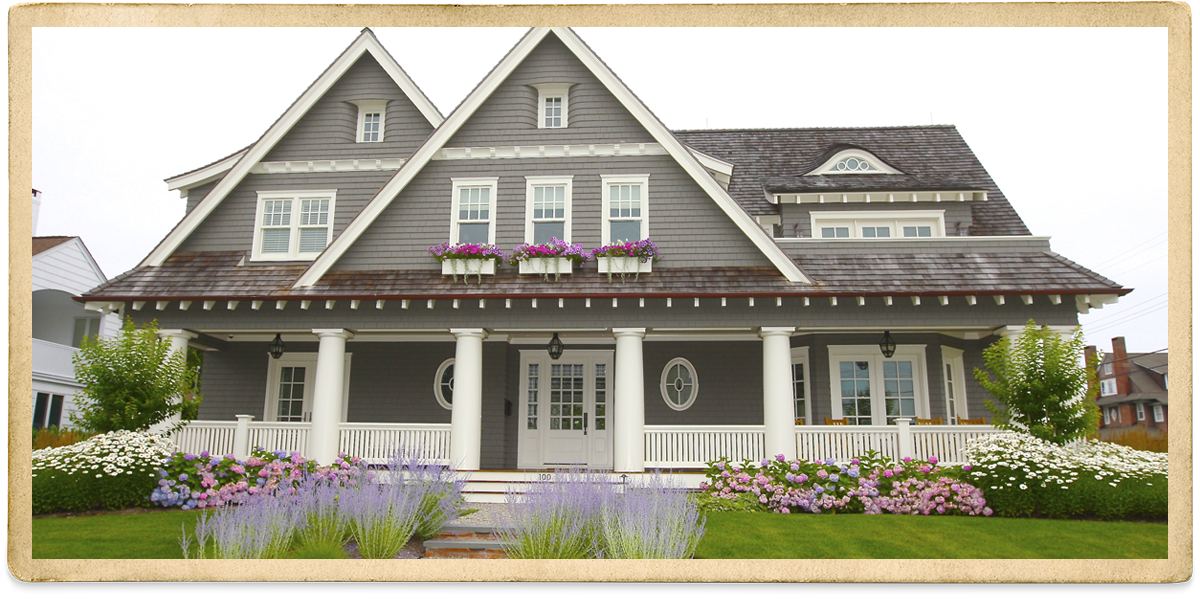 Gray cedar shake two story with white trim and columns on front porch