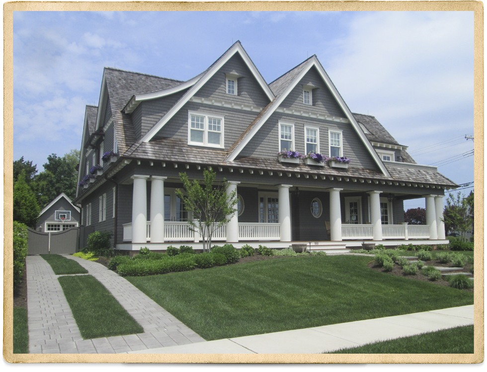 Gray Cedar Shake Two Story With White Trim And Columns On Front Porch